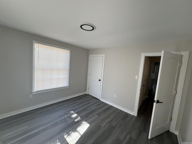 unfurnished bedroom featuring dark wood-type flooring