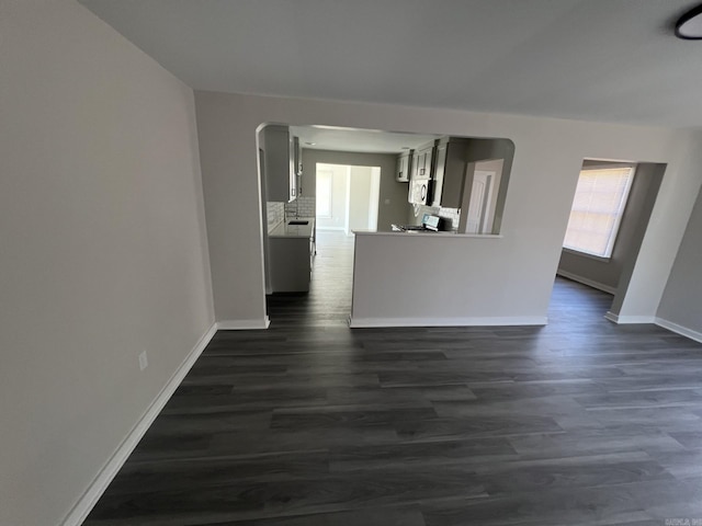 unfurnished room with dark wood-type flooring