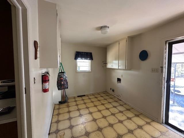 laundry area featuring cabinets