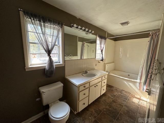 full bathroom with toilet, shower / bath combo, tasteful backsplash, and vanity