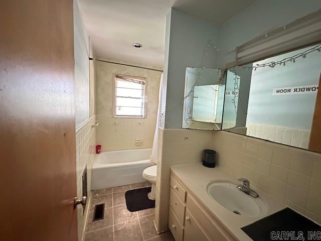 full bathroom with vanity, toilet, tile walls, and shower / tub combo with curtain