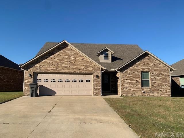 craftsman-style home with a front yard and a garage