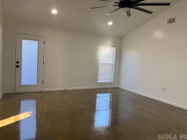 unfurnished room featuring lofted ceiling and ceiling fan