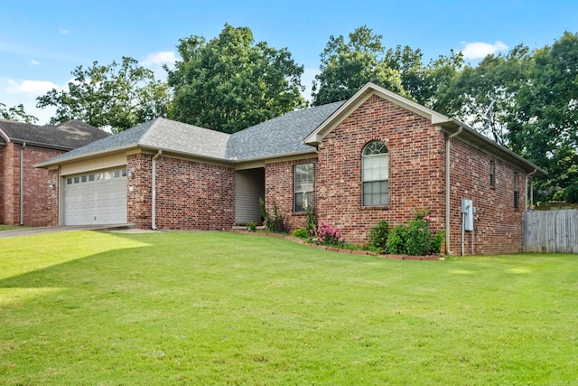 view of front of home featuring a front lawn and a garage