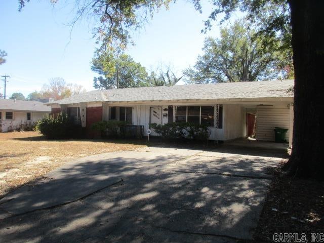 single story home featuring a carport