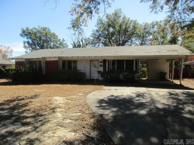 ranch-style house featuring a carport