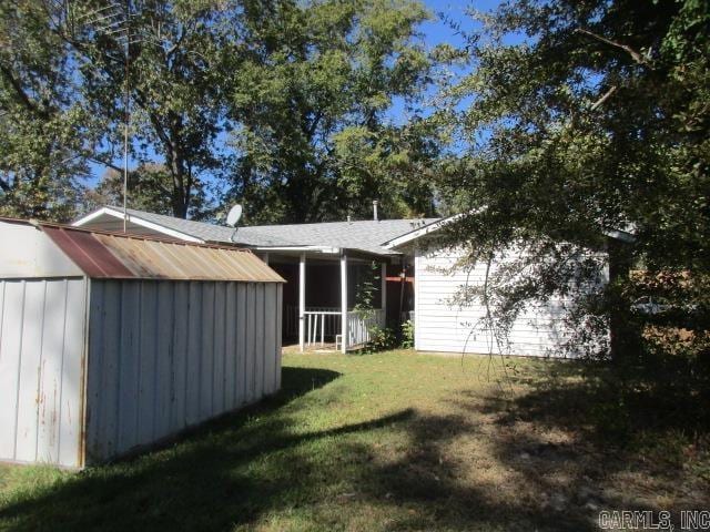 exterior space featuring a shed and a lawn