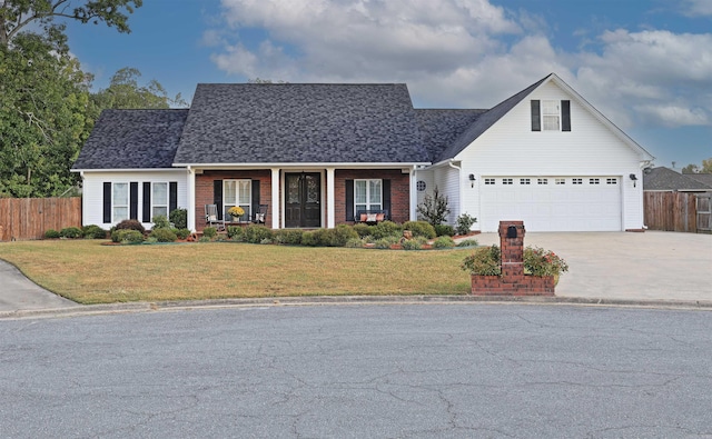 view of front of home featuring a front yard and a garage