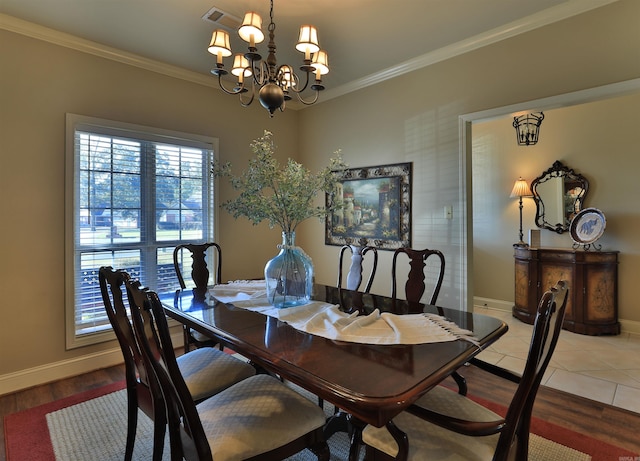 dining room with crown molding, wood-type flooring, and an inviting chandelier