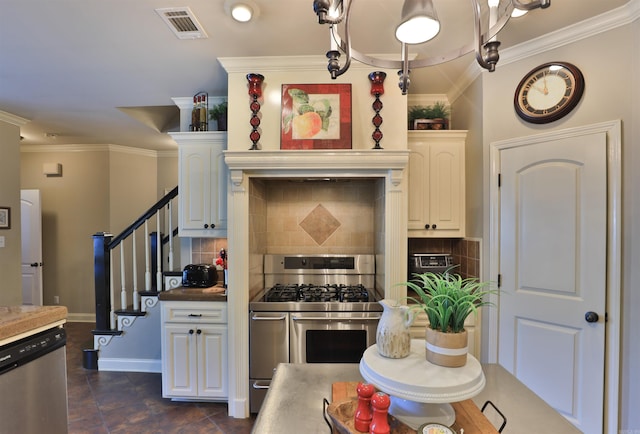 kitchen with appliances with stainless steel finishes, white cabinetry, and backsplash