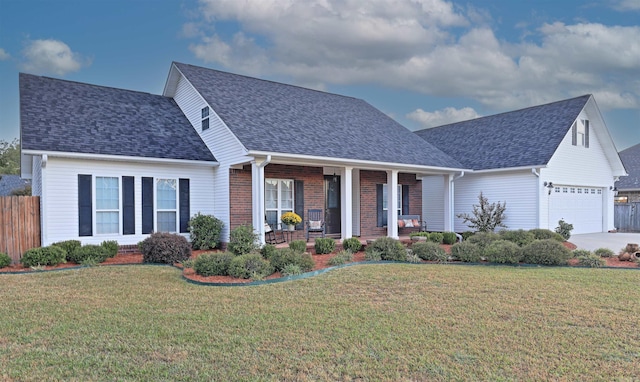 view of front of home featuring a garage, a front lawn, and a porch