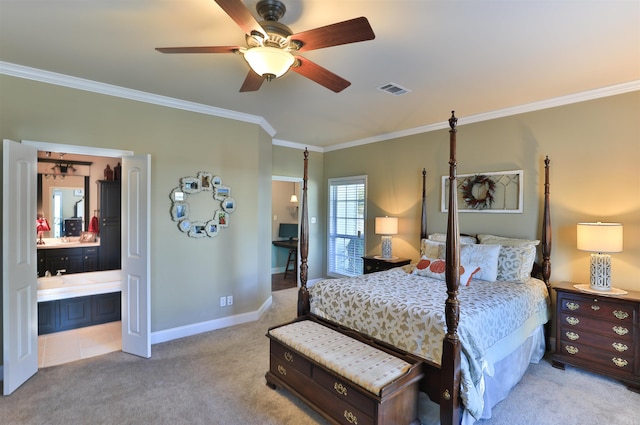 carpeted bedroom featuring ensuite bath, ornamental molding, and ceiling fan