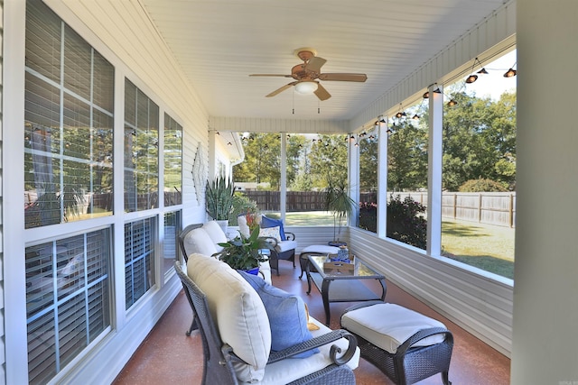 sunroom / solarium featuring ceiling fan