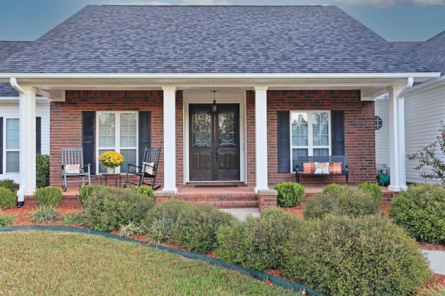 entrance to property featuring a porch