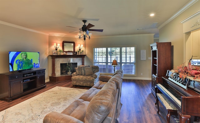 living room with a fireplace, wood finished floors, a ceiling fan, and crown molding