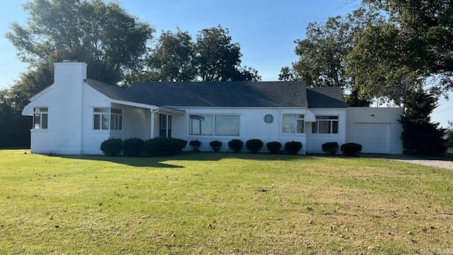 single story home with a front lawn and a garage