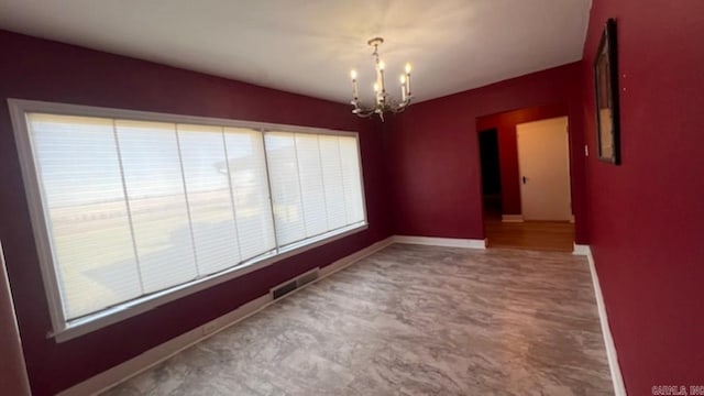 unfurnished dining area with a chandelier and plenty of natural light