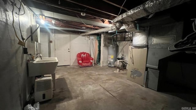 basement featuring sink and water heater