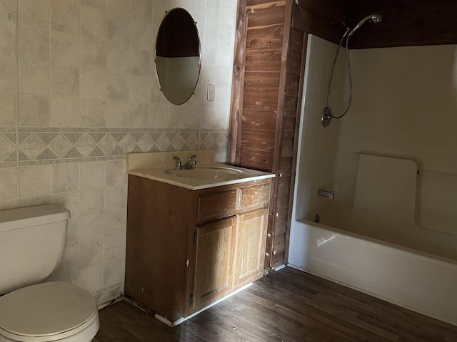 203 Mcclamrock, Portia, AR 72457 - full bath with wood finished floors, vanity, bathtub / shower combination, tile walls, and toilet