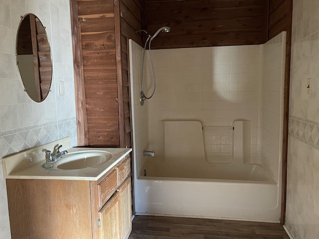 203 Mcclamrock, Portia, AR 72457 - bathroom with washtub / shower combination, wood finished floors, and vanity
