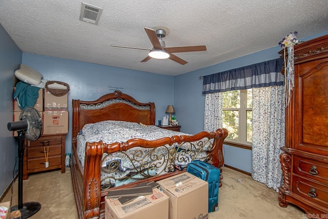 carpeted bedroom with a textured ceiling and ceiling fan