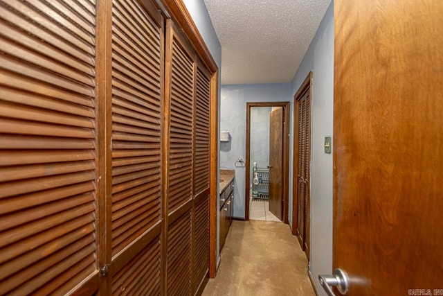 hall featuring a textured ceiling