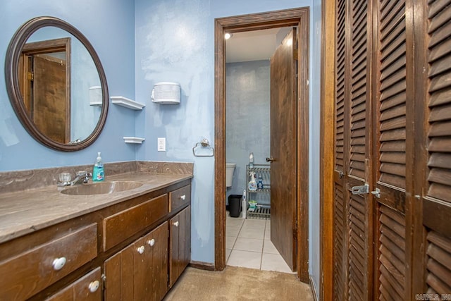 bathroom with vanity, toilet, and tile patterned flooring