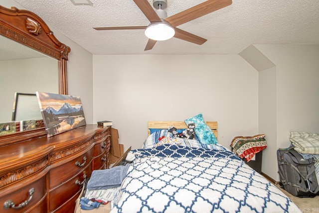 carpeted bedroom featuring ceiling fan and a textured ceiling