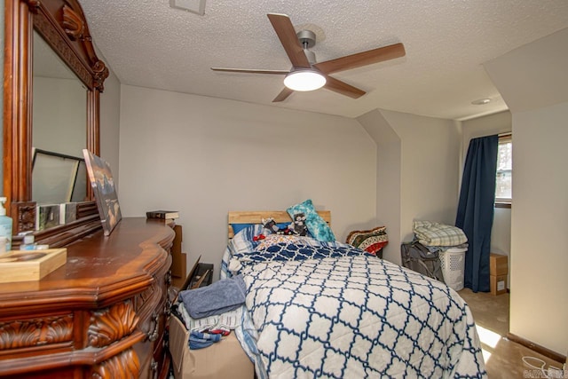 carpeted bedroom featuring a textured ceiling and ceiling fan