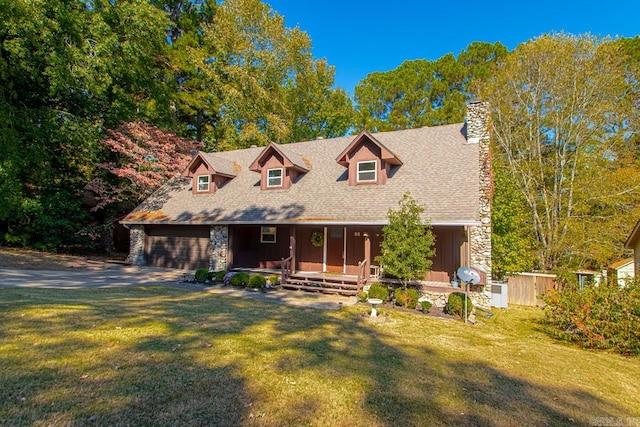 cape cod home with a front yard and a garage