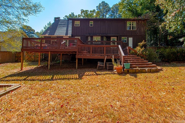 rear view of house featuring a deck and a lawn