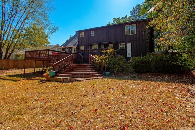 rear view of house with a yard and a deck