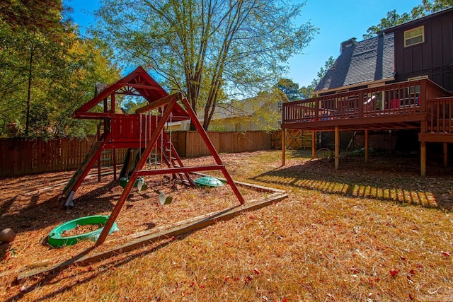 view of play area featuring a yard and a deck