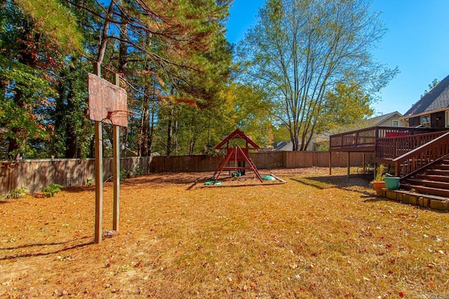 view of yard with a wooden deck and a playground