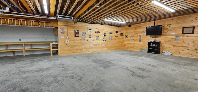 garage featuring a workshop area and wood walls