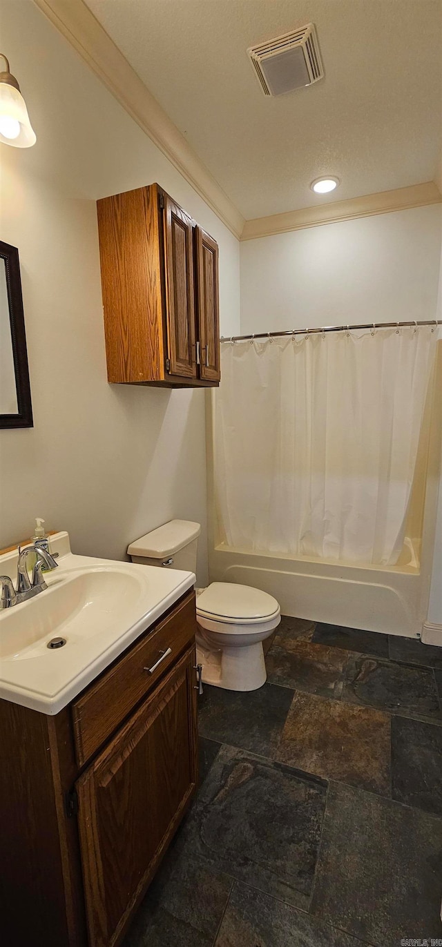 full bathroom with vanity, shower / bath combo, and toilet