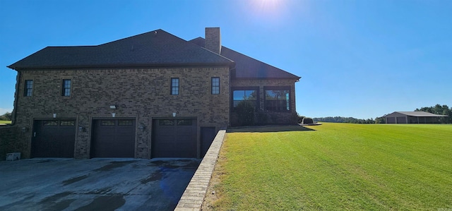 view of side of home with a garage and a lawn