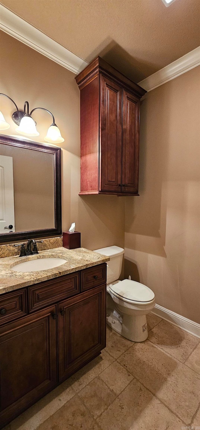 bathroom with vanity, crown molding, a textured ceiling, and toilet