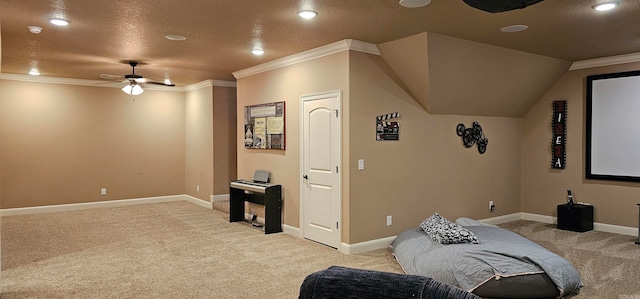 cinema room with light carpet, crown molding, a textured ceiling, and ceiling fan