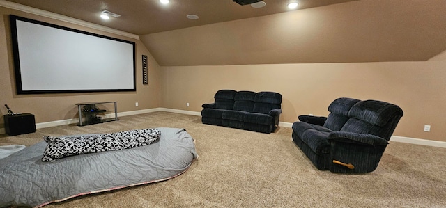 home theater room with carpet floors and vaulted ceiling