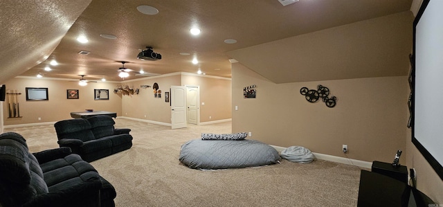 carpeted home theater featuring ceiling fan, crown molding, a textured ceiling, and vaulted ceiling