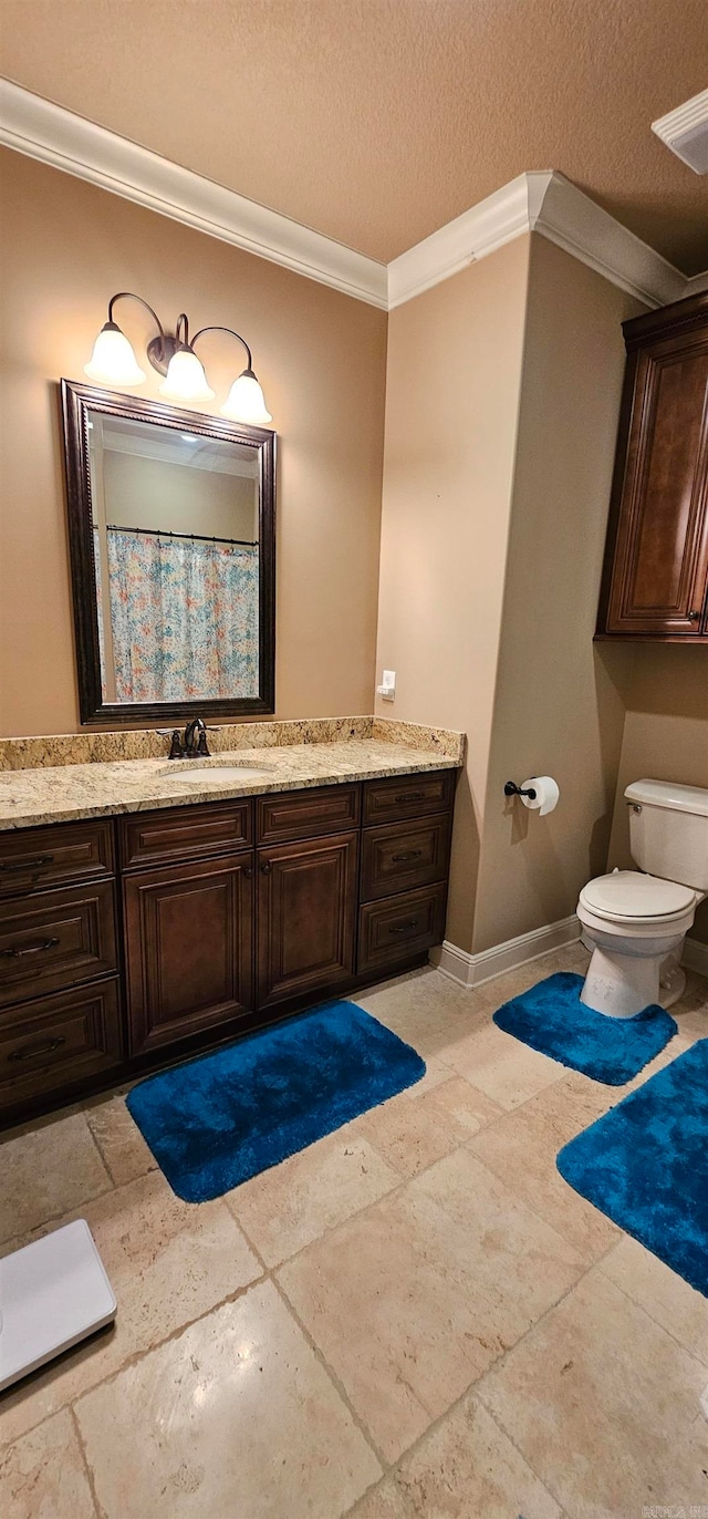 bathroom featuring vanity, crown molding, a textured ceiling, and toilet