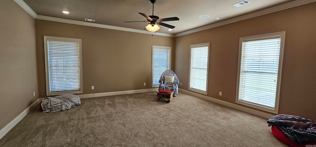 recreation room featuring carpet, ceiling fan, ornamental molding, and a textured ceiling