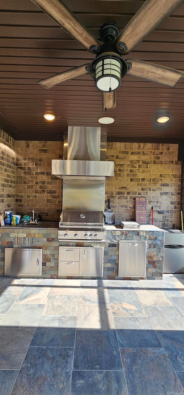 view of patio with grilling area, sink, and exterior kitchen