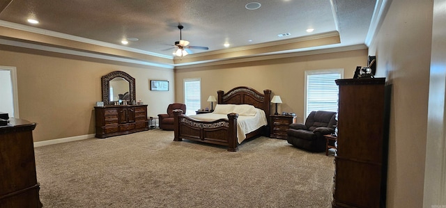 bedroom with ornamental molding, a raised ceiling, light carpet, and ceiling fan