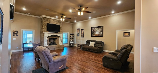 living room featuring ceiling fan, a stone fireplace, wood-type flooring, and ornamental molding