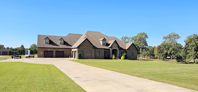 view of front of house with a garage and a front lawn