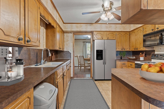 kitchen featuring sink, stainless steel fridge, white electric stove, a textured ceiling, and ceiling fan