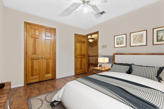 bedroom with ceiling fan and dark hardwood / wood-style flooring