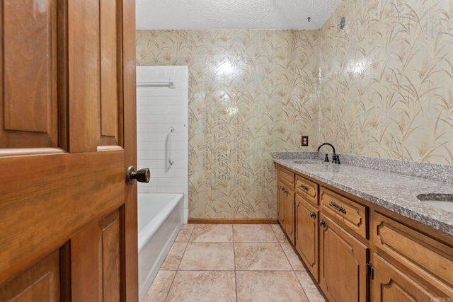 bathroom with vanity, a textured ceiling, tile patterned flooring, and shower / bathtub combination